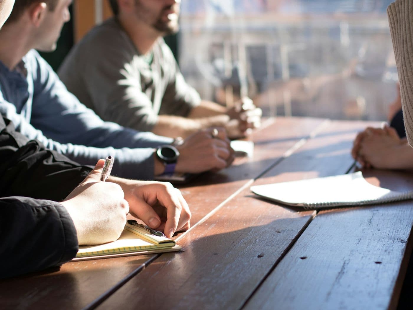 Deux personnes autour d'une table de travail, prise de notes.